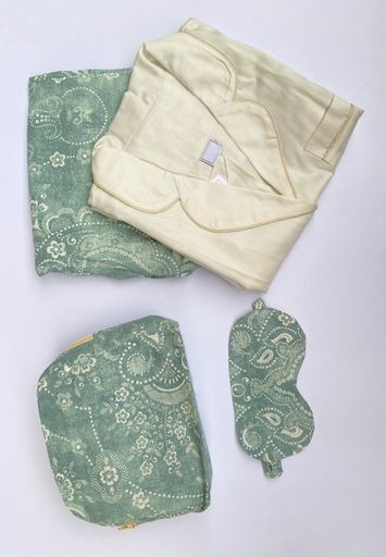 A vertical overhead shot of luxurious pyjamas on a white surface
