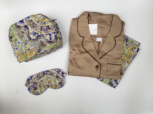 A high angle shot of luxurious pyjamas on a white surface
