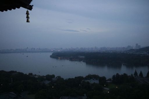 A dramatic shot of Powai lake with the buildings in the background on a foggy day