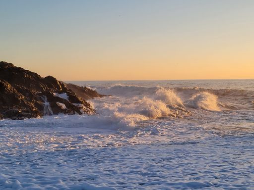 A beautiful view of ocean waves against a sunset sky background