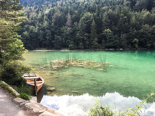 A beautiful shot of a boat parked by the shore of Alatsee lake in Germany, Bavaria