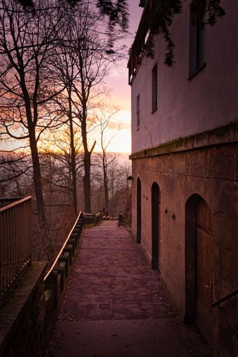 A vertical shot of Bastei bridge in Saxon Switzerland National Park under colorful susnet