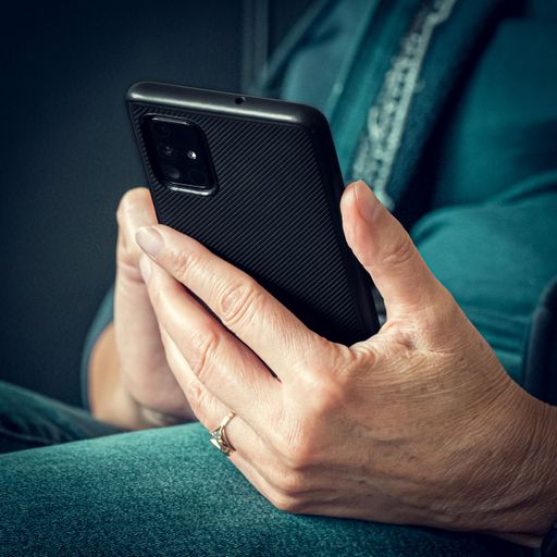 A closeup of a woman holding smart phone in her hand
