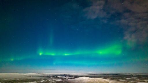 Northern lights, in moon light, winter night in Lapland - aerial view