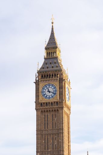 A scenic view of the iconic Big Ben clock tower, situated next to the River Thames in London, England, as seen from across the river