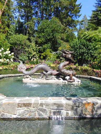 A vertical closeup shot of a dragon water fountain in the Butchart Gardens, Canada