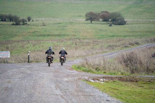 A pair of motorcyclists riding on an off-road bike in a rural area in Salisbury, UK