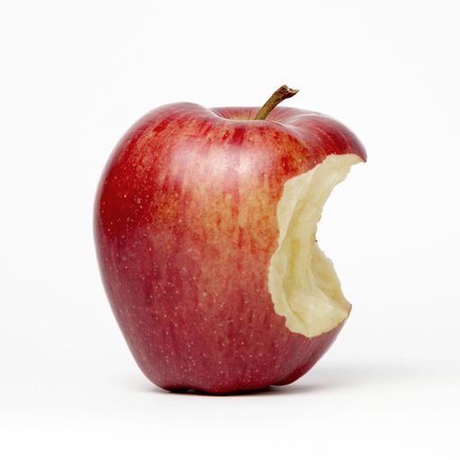 A closeup shot of a half-eaten apple on a white surface