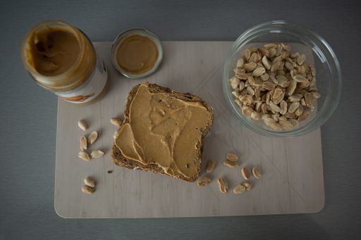 A top view of bread with chocolate spread and nuts