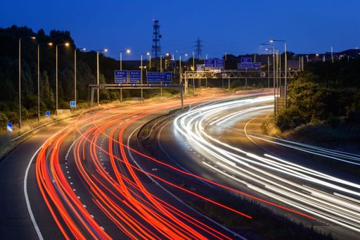 Light trails and streaks of light are left by fast moving traffic on the M5 motorway near Bristol during the early evening.