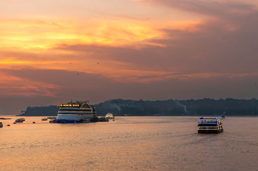 Panaji Goa India Oct 22 2022: Sunset time cruise View of the Atal Setu bridge and activities in the Mandovi river including the river casinos in Goa