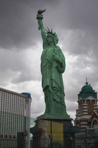 A stunning image of the iconic Statue of Liberty in New York City set against a cloudy sky