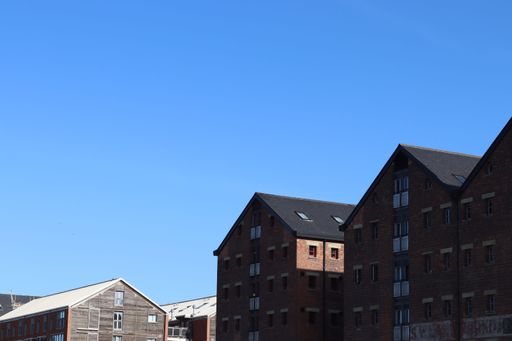 The two tall brick structures standing side by side illuminated by the bright sunshine of the day