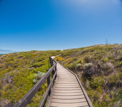 A scenic boardwalk stretching along the shoreline, providing a beautiful pathway to access the beach