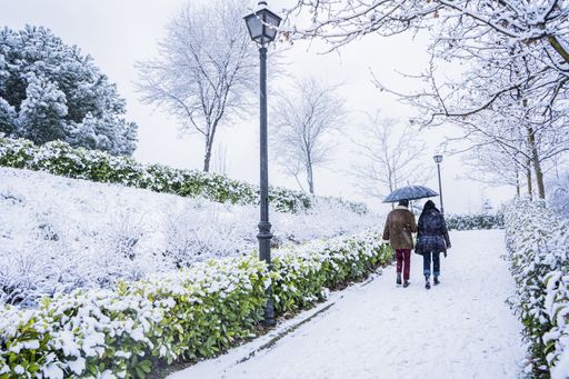 A couple walking in a snowy park in Madrid, Spain in 2021