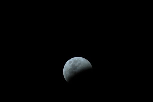 A beautiful view of a Partial Lunar Eclipse before totality on a black background
