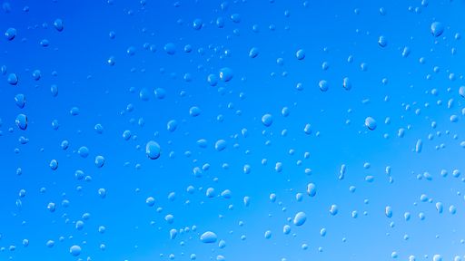 A closeup shot of the water drops over the glass surface