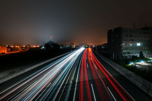 A long exposure of a highway with light trails on a foggy night in Bienne
