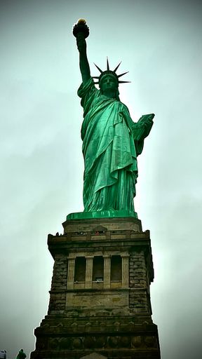 A low-angle shot of the statue of liberty against the sky background, New York City, USA