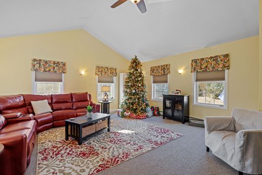 The interior design on a beautiful home with a red sofa and a Christmas tree