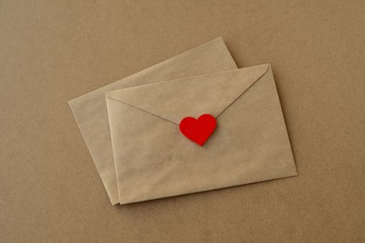 Valentine's day. Love letters envelopes and red heart on a background of kraft paper. Valentine card