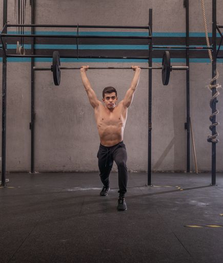 A closeup shot of an Athletic boy lifting weight at gym, fitness concept