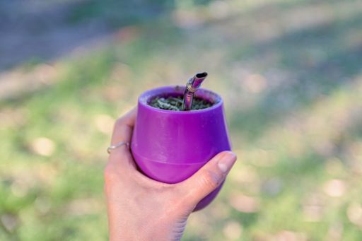 A shallow focus shot of a female holding a yerba mate