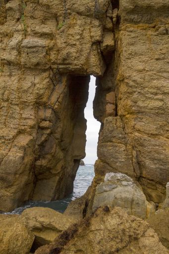 A vertical shot of rock formations  La Arnia beach in Cantabria, Spain