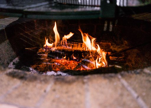 a close up shot of a fire in a brick fire pit