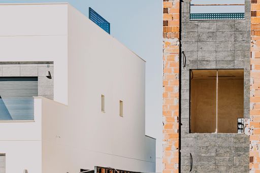 A scenic view of an old with a white painted wall building on a