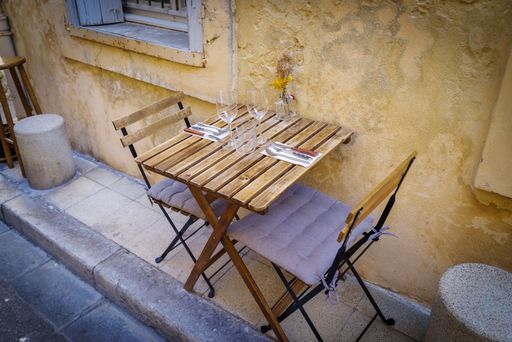 A high-angle shot of a romantic table for two in a mediterranean village. France.