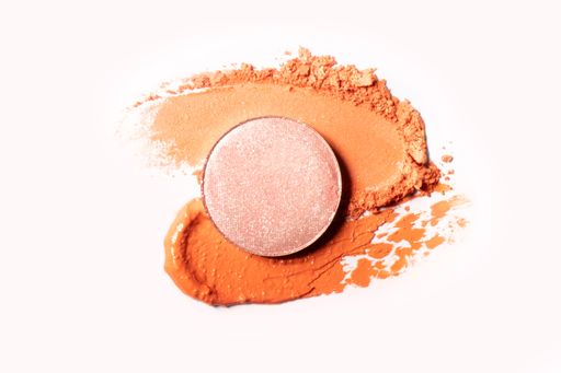 Make up swatches-light pink blush, brick color cream, and dark skin color powder on a white background.