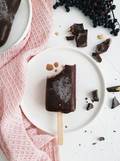 A vertical shot of a chocolate ice cream on a white plate