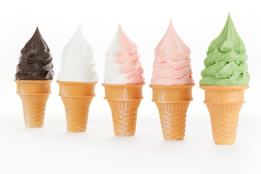A selective focus shot of soft flavored ice cream set in crispy waffle cups