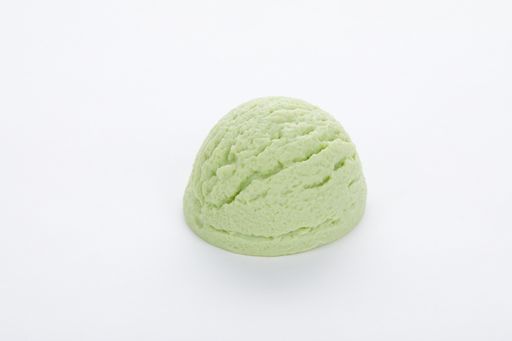 A closeup shot of a delicious pistachio ice cream scoop isolated on a white surface
