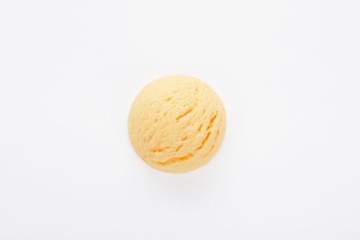 A top view of a delicious mango ice cream scoop isolated on a white surface