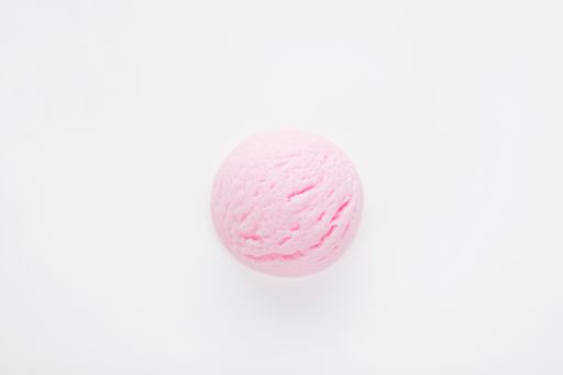 A top view of a delicious strawberry ice cream scoop isolated on a white surface