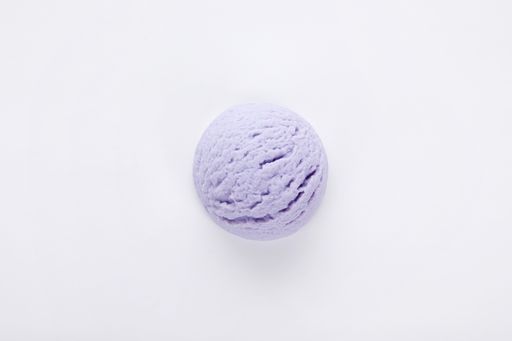 A top view of a delicious blueberry ice cream scoop isolated on a white surface