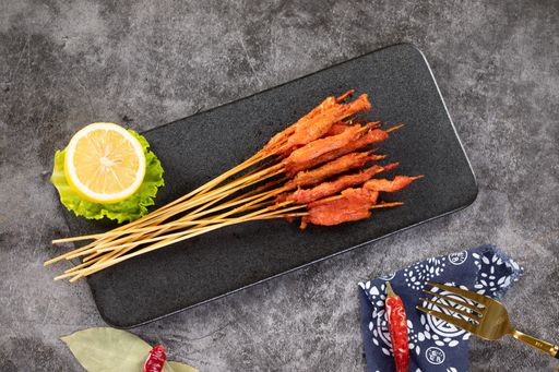 A top view of delicious meat on wooden skewers seasoned with various spices