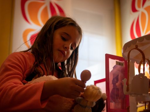 A closeup shot of a preschooler girl plays in a sunny room