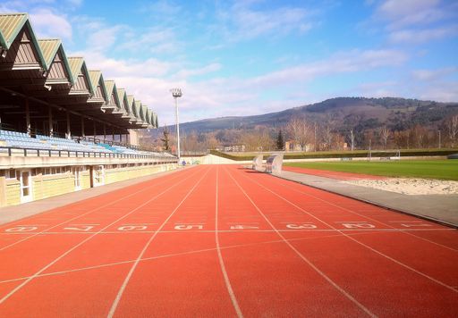 A view of the red running track at the stadium numbered from one to eight