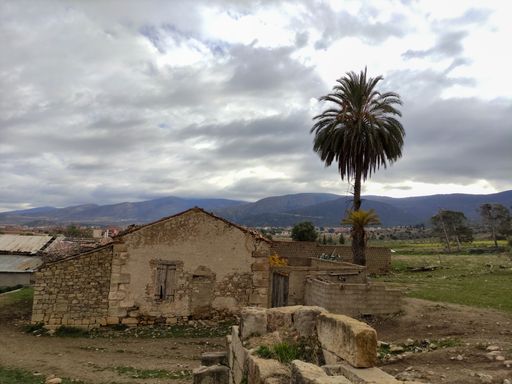 A fantastic shot of an old house with a red roof on a cloudy sky background