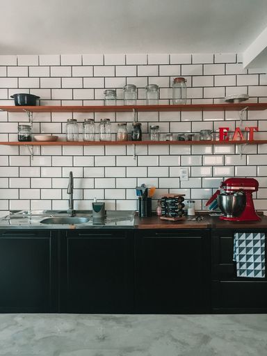 A vertical shot  of a kitchen with white brick wall
