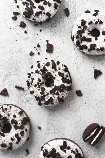 A vertical shot of some tasty donuts covered with cookies