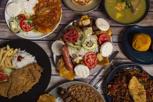 A top view shot of various dishes of Colombian cuisine on the restaurant table