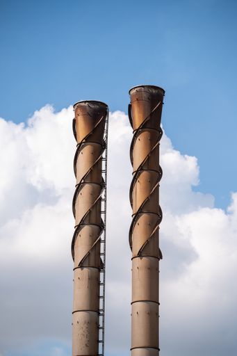 A vertical shot of the chimneys of an industrial factory und