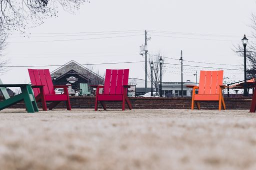 Duluth, Georgia | United States - January 7, 2021: Adirondack chairs in the grass outside in a small suburban city park