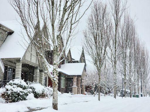 A beautiful shot of a row of condo houses covered in snow in the winter