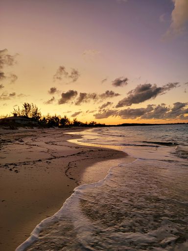 A scenic sunset over a sandy beach