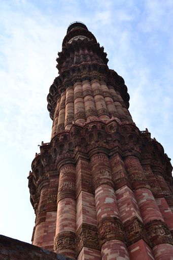 A vertical shot of an ancient high building on sky background